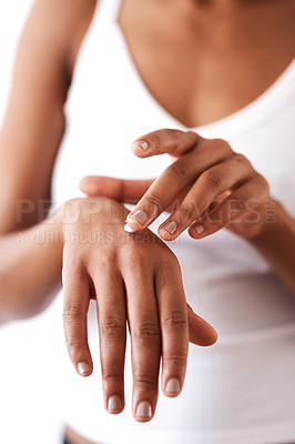 Buy stock photo Studio shot of an unrecognizable woman moisturising her hands