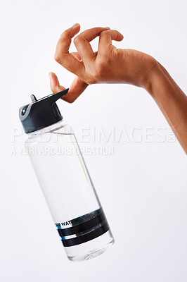 Buy stock photo Studio shot of an unrecognizable woman holding a water bottle against a white background