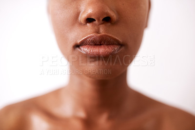 Buy stock photo Closeup shot of a beautiful young woman posing with glossy lips against a white background