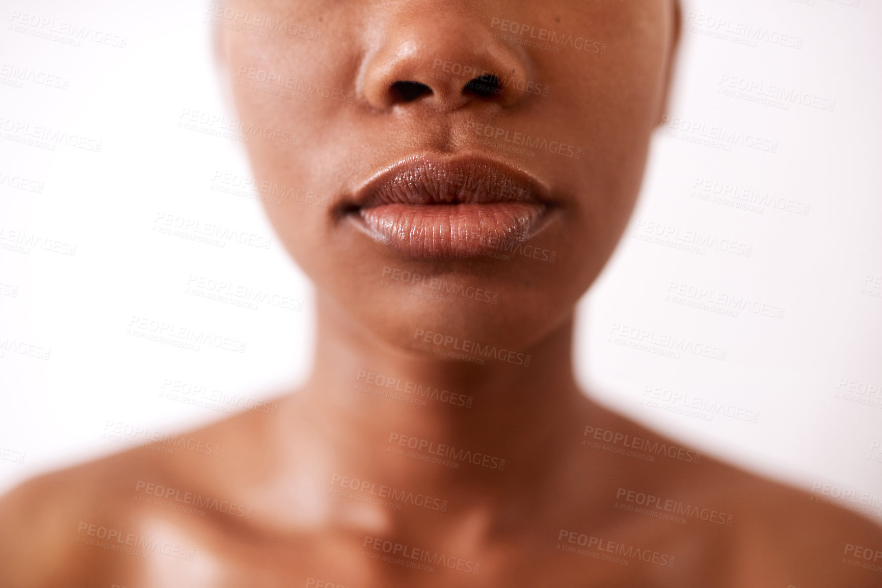 Buy stock photo Closeup shot of a beautiful young woman posing with glossy lips against a white background