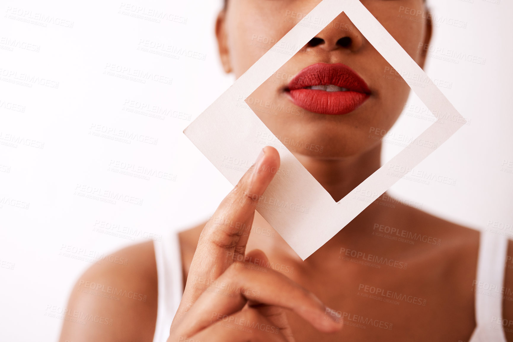 Buy stock photo Studio shot of an unrecognizable woman holding a frame over her red lips