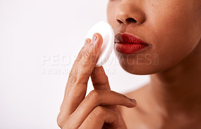 Buy stock photo Studio shot of an unrecognizable woman using a cotton pad to remove her lipstick