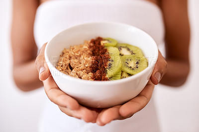 Buy stock photo Woman, hands and bowl with kiwi or oats for diet, healthy meal or snack in studio on a white background. Closeup, female person or model with fruit or natural organic food for breakfast or nutrition