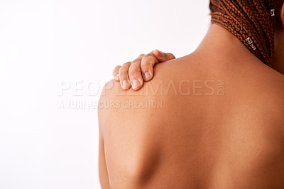 Buy stock photo Studio shot of an unrecognizable woman touching her shoulder
