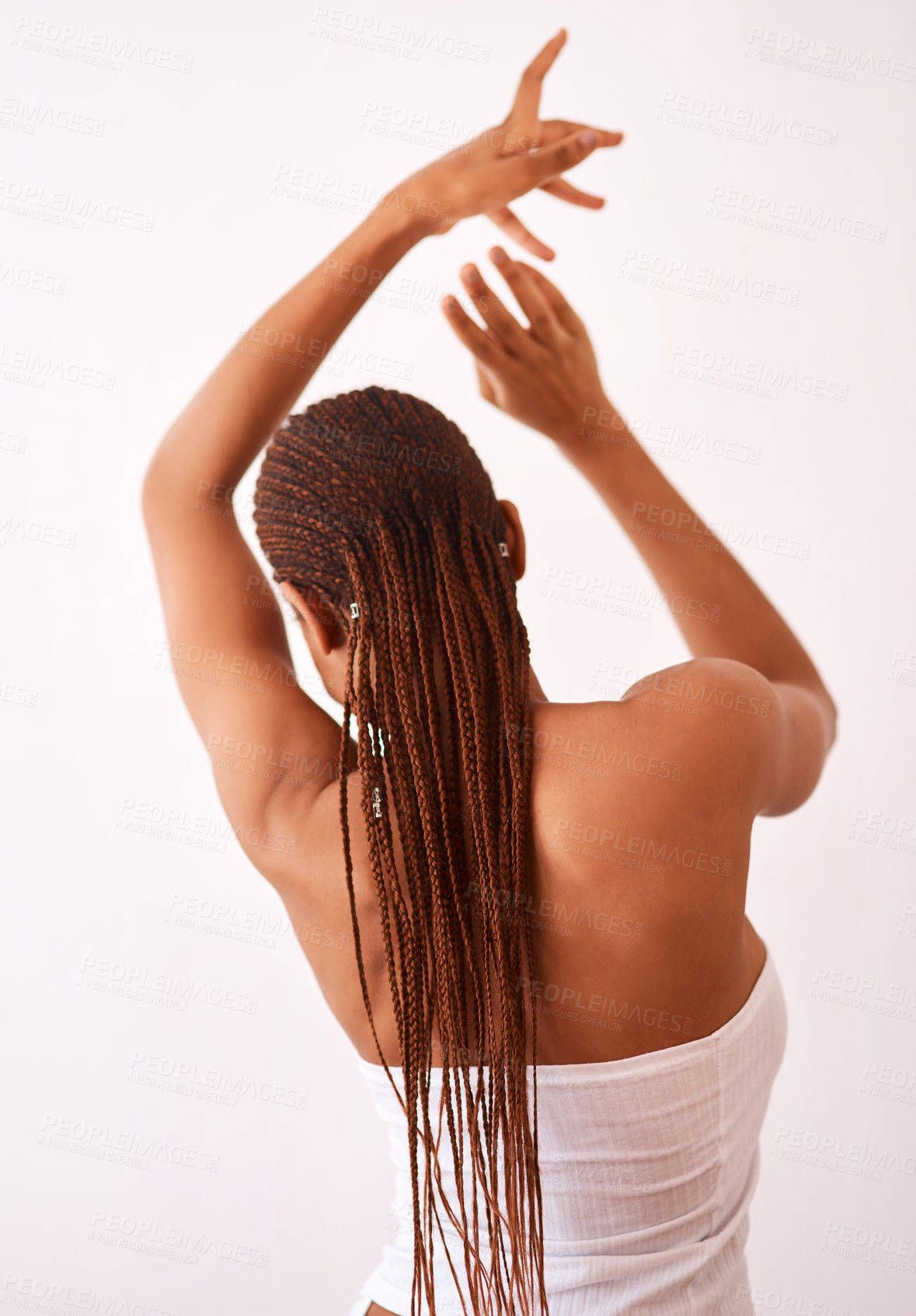 Buy stock photo Studio shot of a woman with braids posing with her back towards the camera