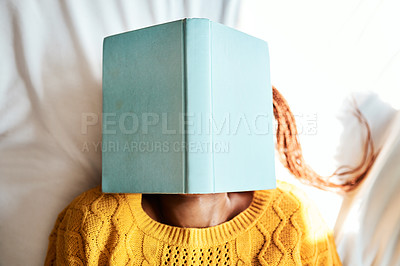 Buy stock photo Shot of an unrecognizable woman lying with a book over her face