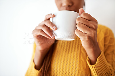 Buy stock photo Cropped shot of an unrecognizable woman drinking a cup of coffee