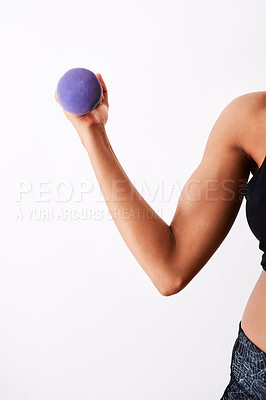 Buy stock photo Studio shot of a muscular woman working out using dumbbells