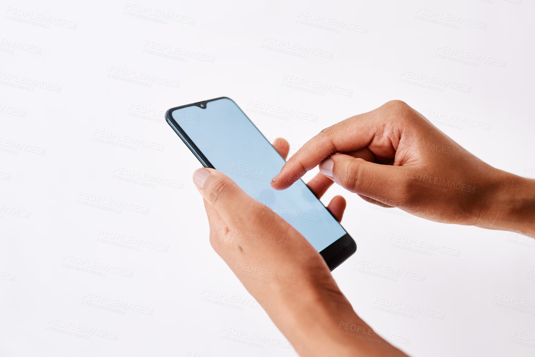 Buy stock photo Studio shot of an unrecognizable woman holding a cellphone against a white background