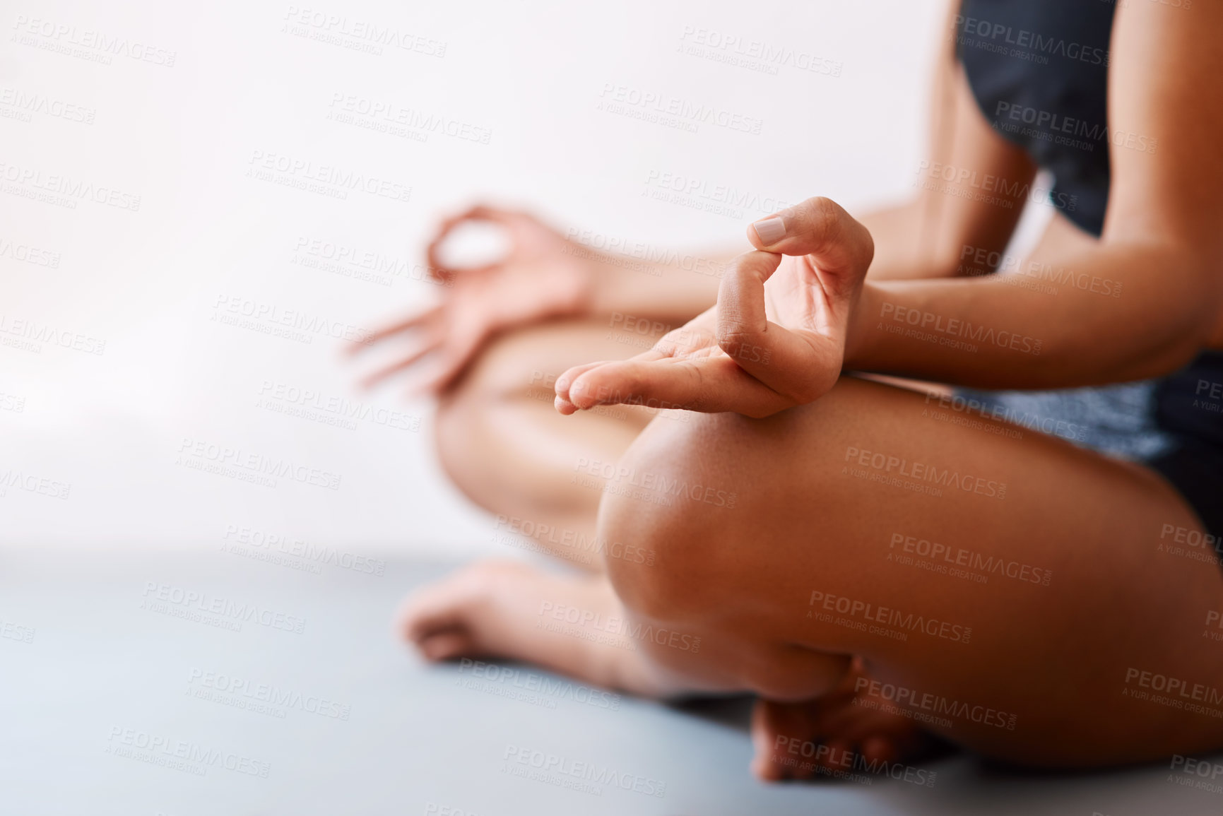 Buy stock photo Cropped shot of an unrecognizable woman practising yoga against a white background