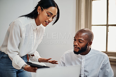 Buy stock photo Shot of a young businessman and businesswoman using a digital tablet during a meeting in a modern office