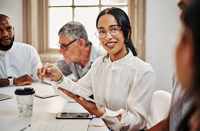 Buy stock photo Shot of a young businesswoman using a digital tablet during a meeting in a modern office