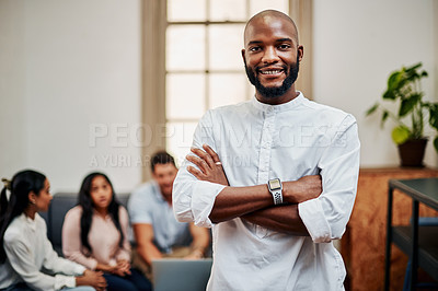 Buy stock photo Portrait of a young businessman working in a modern office with his colleagues in the background