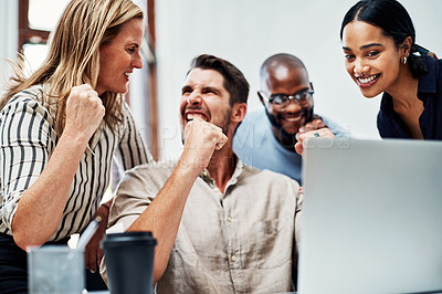 Buy stock photo Cropped shot of a group of business colleagues cheering while gathered around a laptop in the office