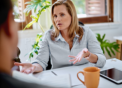 Buy stock photo Shot of a mature businesswoman having a discussion with a colleague in an office