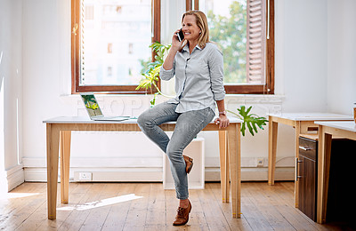 Buy stock photo Shot of a mature businesswoman talking on a cellphone in an office