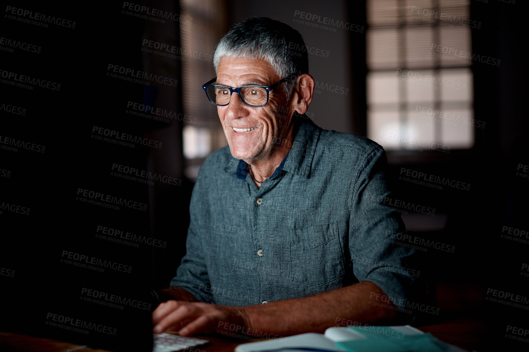 Buy stock photo Senior man, night and computer in office for digital report deadline, admin and online research. Elderly journalist, pc and working overtime for editing story, reading and writing article in dark