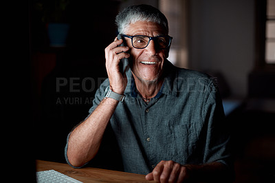 Buy stock photo Shot of a senior businessman talking on a cellphone in an office at night
