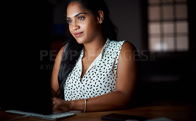 Buy stock photo Shot of a young businesswoman working on a computer in an office at night