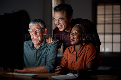 Buy stock photo Shot of a group of businesspeople working on a computer in an office at night