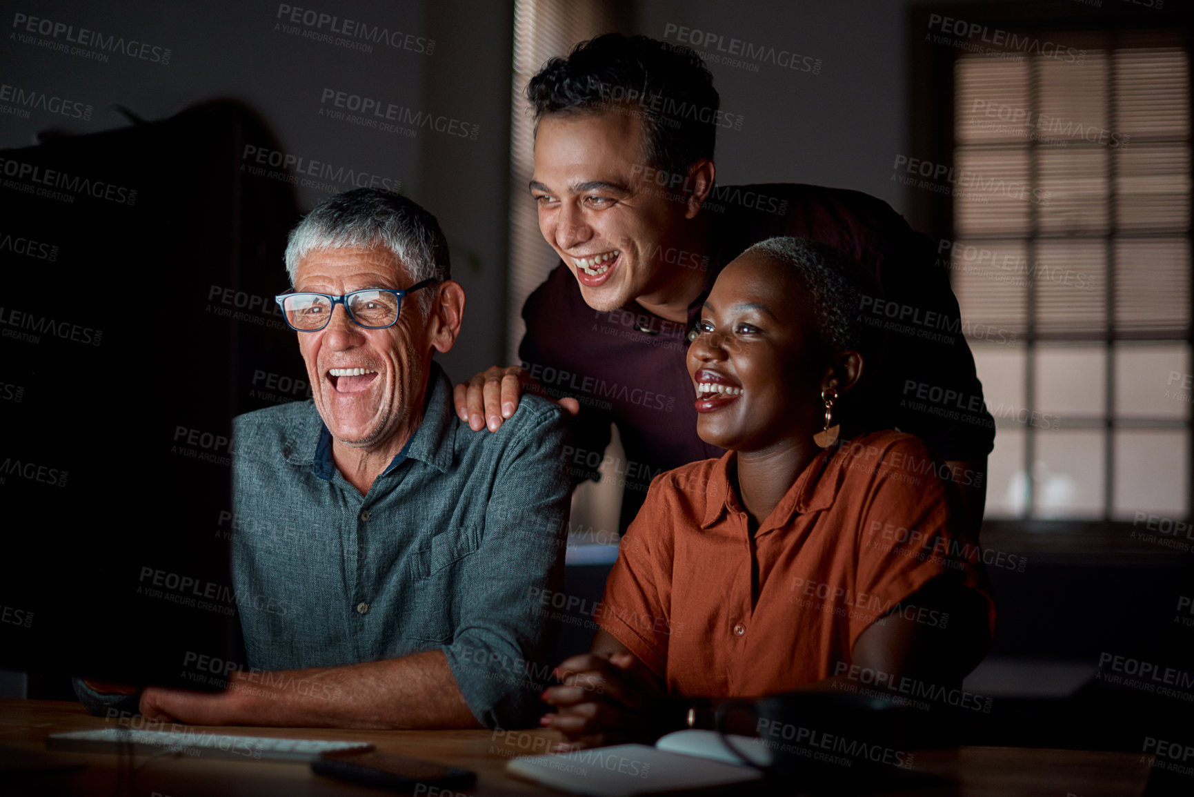 Buy stock photo Creative, team and laughing in office at night with computer for creating blog post, online and developing content strategy. Copywriter, group and working late for proofreading, editing and deadline.