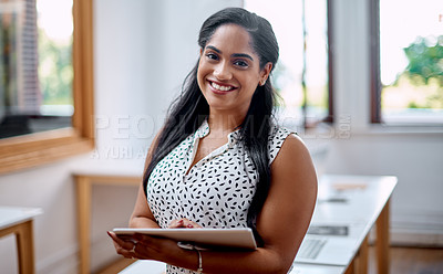 Buy stock photo Portrait of a young businesswoman using a digital tablet in an office