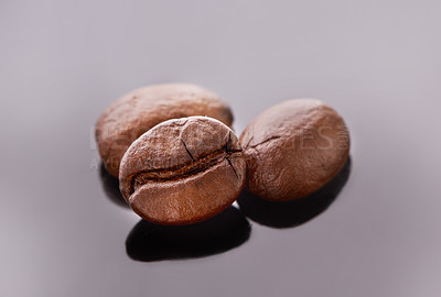 Buy stock photo Studio shot of coffee beans against a grey background