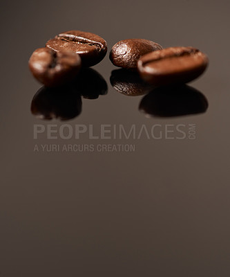Buy stock photo Studio shot of coffee beans against a brown background