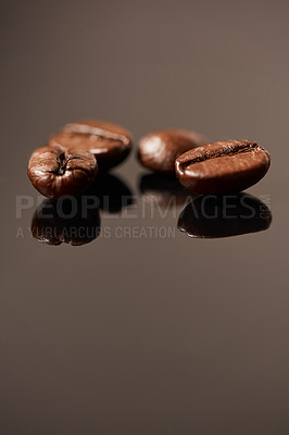 Buy stock photo Studio shot of coffee beans against a brown background