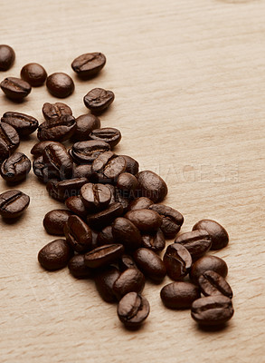 Buy stock photo Still life shot of coffee beans on a wooden countertop