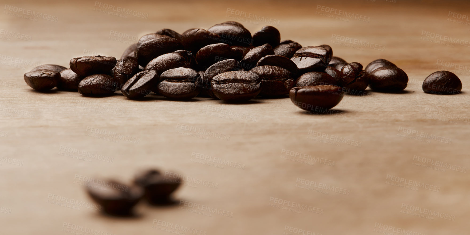 Buy stock photo Still life shot of coffee beans on a wooden countertop