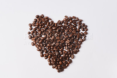 Buy stock photo Studio shot of coffee beans shaped in a heart against a white background