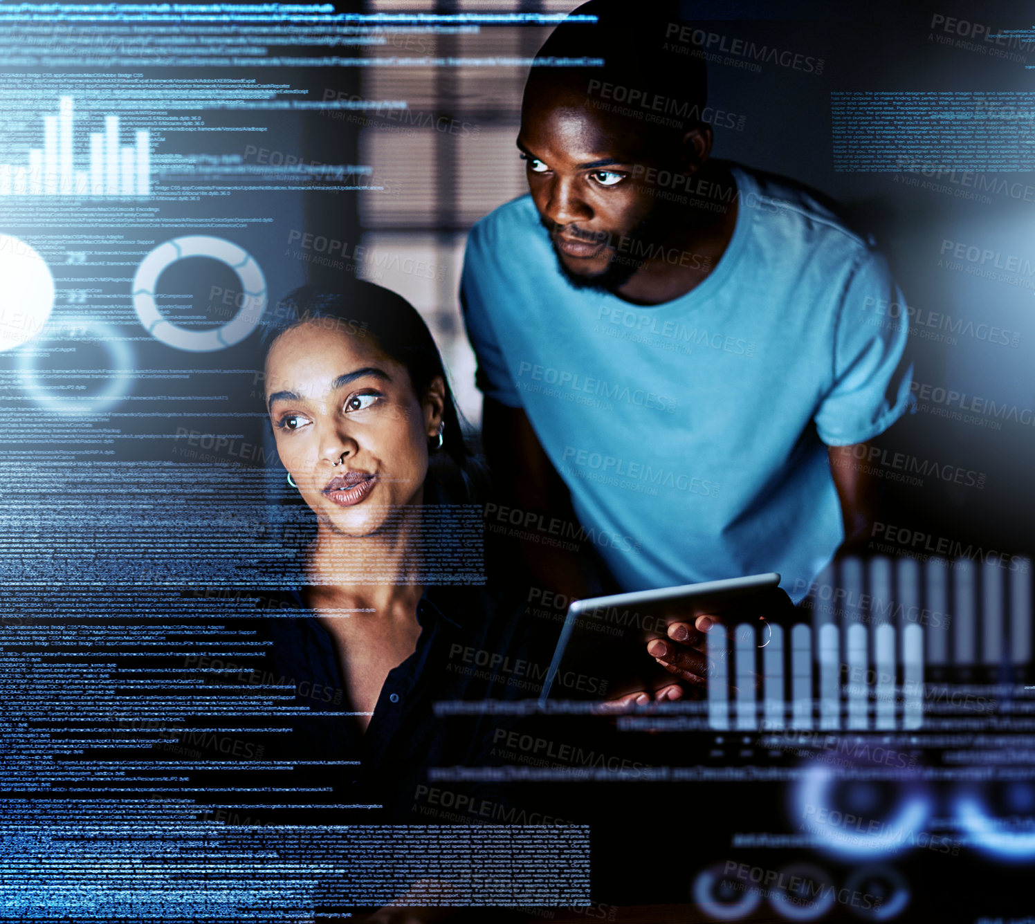 Buy stock photo Shot of two programmers working together on a computer code at night
