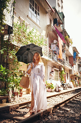 Buy stock photo Travel insurance, umbrella and walking with woman on train tracks for explore, adventure and policy cover. Protection, tourism and relax with person in Vietnam for paradise, journey and railway