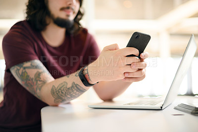 Buy stock photo Closeup shot of an unrecognisable businessman using a cellphone in an office