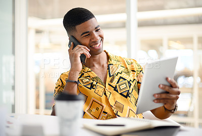 Buy stock photo Shot of a young businessman talking on a cellphone while using a digital tablet in an office