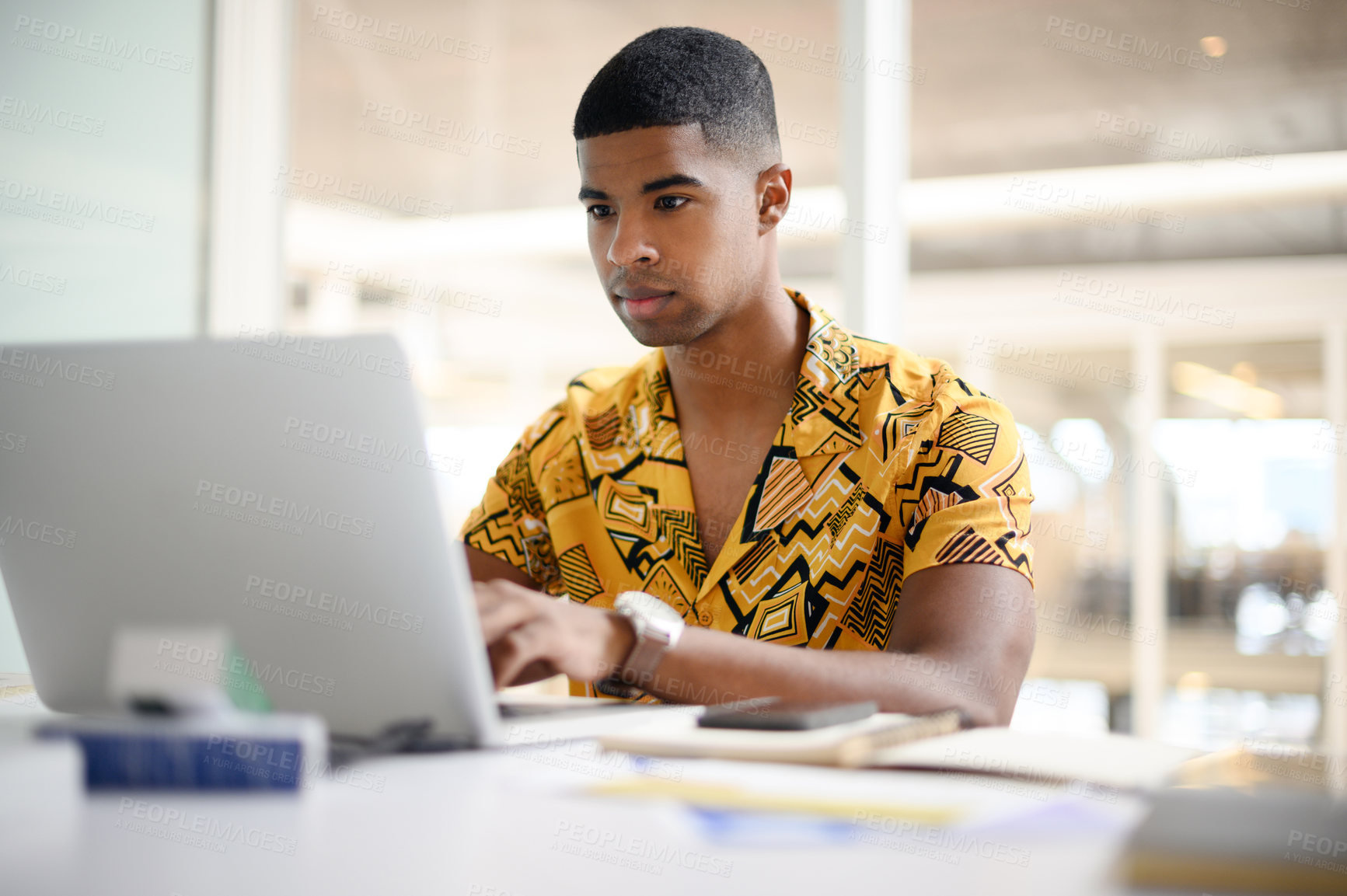 Buy stock photo Businessman, reading and typing on laptop in office for email feedback, communication or networking. Digital designer, intern and tech for online content review and social media marketing campaign