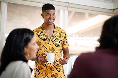 Buy stock photo Shot of a young businessman having a discussion with his colleagues in an office