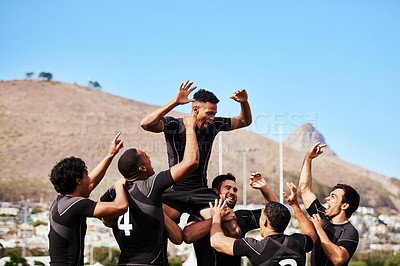 Buy stock photo Shot of a group of young rugby players celebrating after winning a game