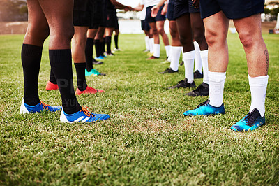 Buy stock photo Cropped shot of a group of rugby players shaking hands on the field