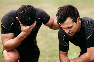 Buy stock photo Shot of two young men looking upset while playing a game of rugby