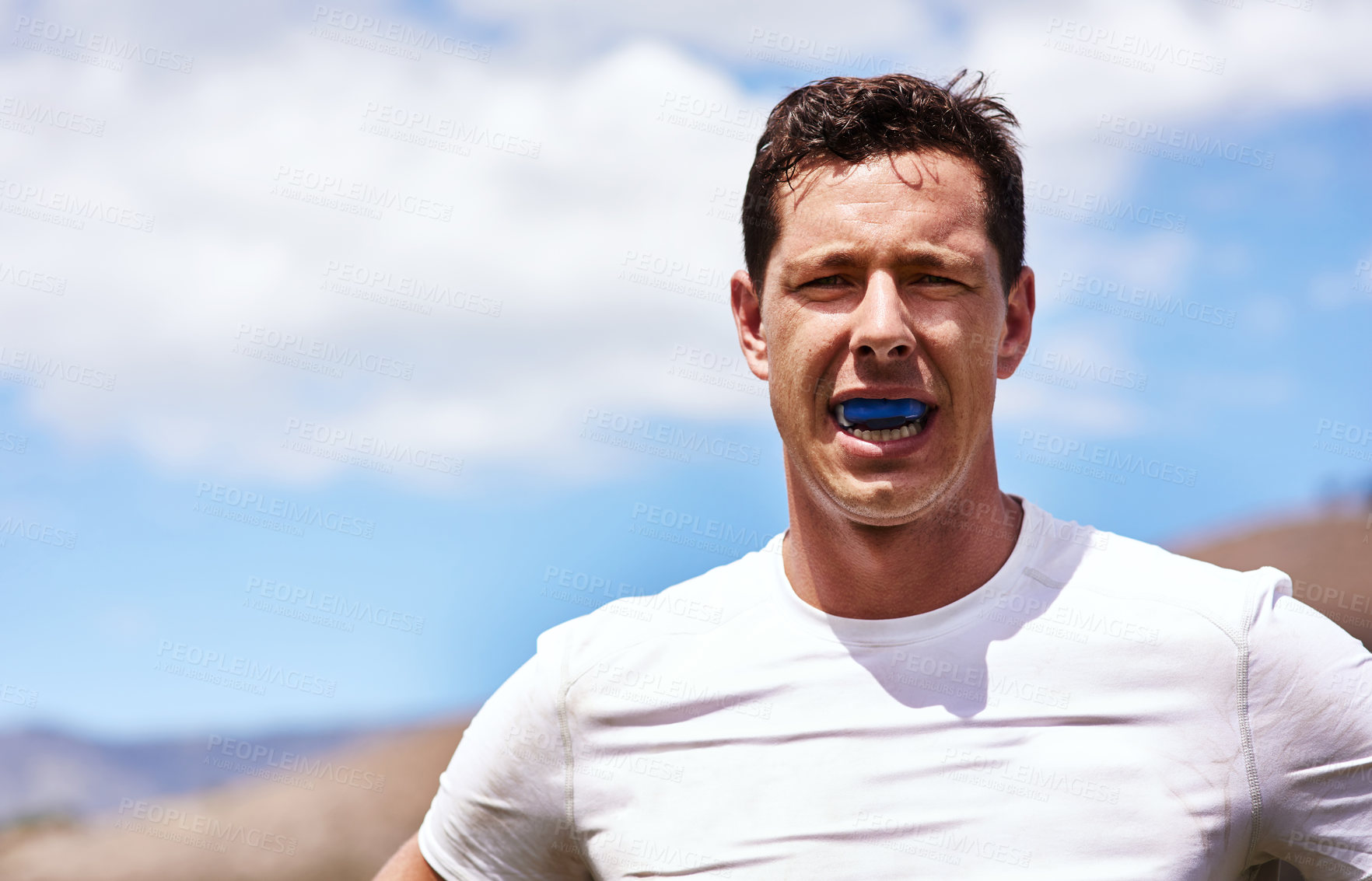 Buy stock photo Portrait of a young man wearing a gum guard while playing a game of rugby