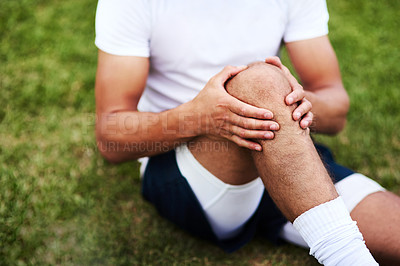 Buy stock photo Cropped shot of a man injuring his knee during a rugby game