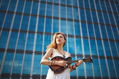 Buy stock photo Music, fashion and woman with guitar in city for street performance, playing tune and practice songs. Musician, artist and person with musical instrument for sound, hobby and entertainment in town