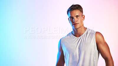 Buy stock photo Studio portrait of a handsome young male athlete posing against a multi-coloured background