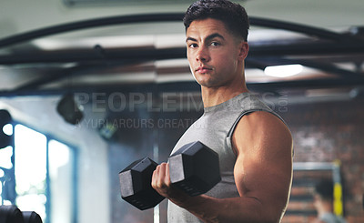 Buy stock photo Portrait of a sporty young man exercising with a dumbbell at the gym