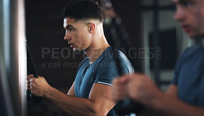 Buy stock photo Shot of a sporty young man exercising at the gym
