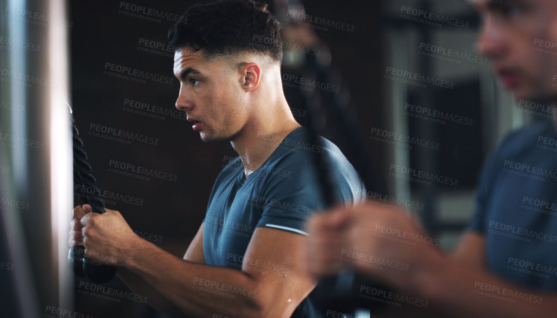Buy stock photo Shot of a sporty young man exercising at the gym