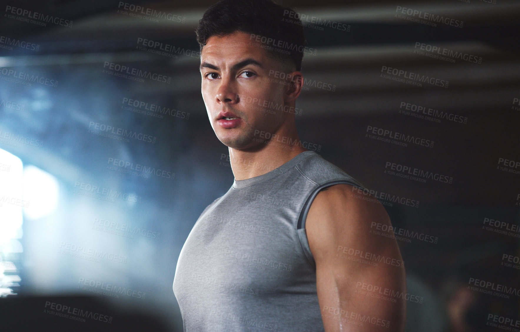 Buy stock photo Portrait of a sporty young man exercising at the gym