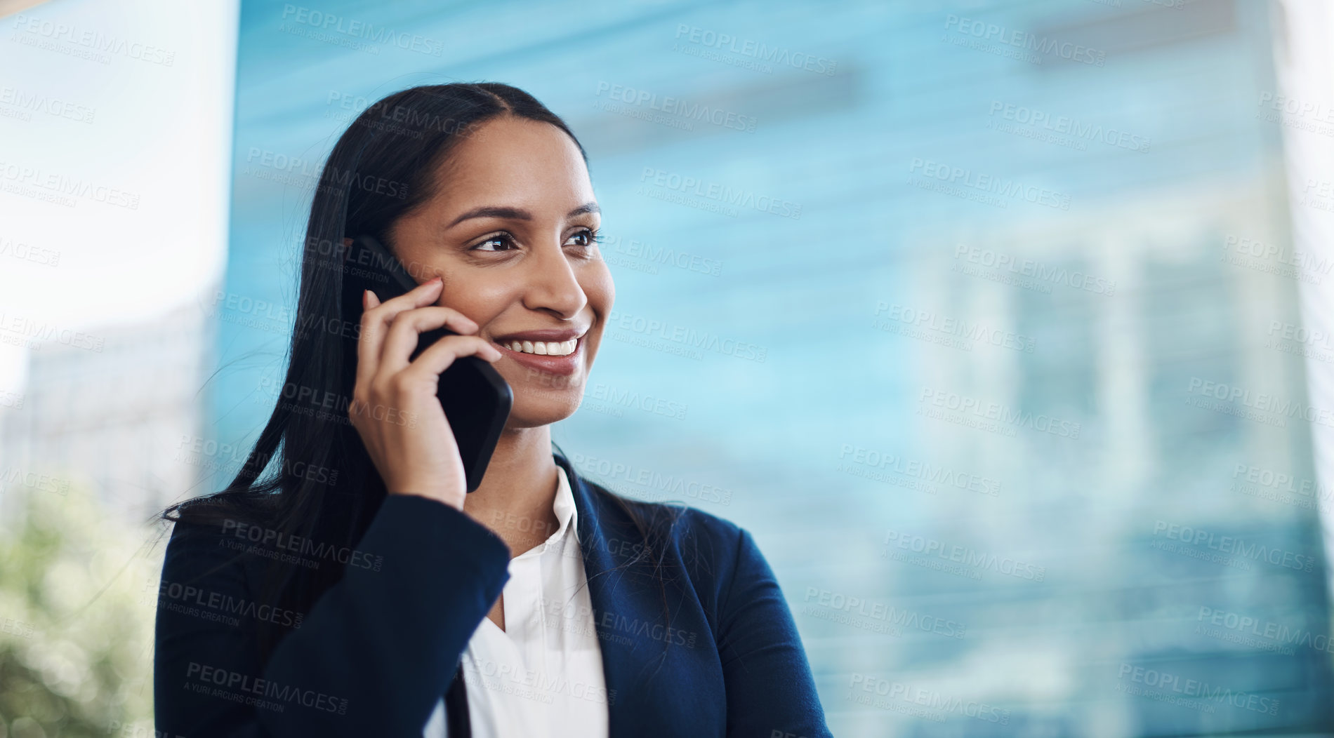 Buy stock photo Shot of a young businesswoman using a smartphone against a city background